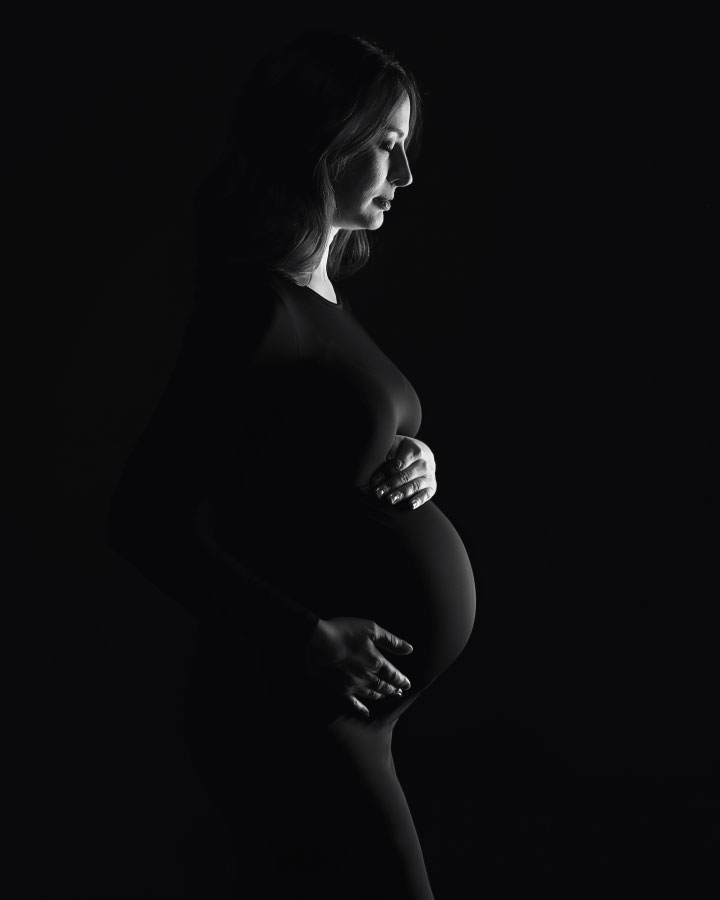 Hiram maternity photographer, dark silhouette studio portrait