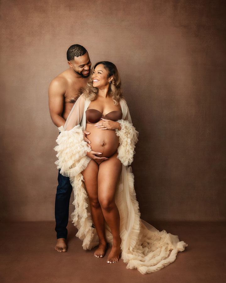 Villa Rica maternity photographer, studio portrait of expecting couple on brown