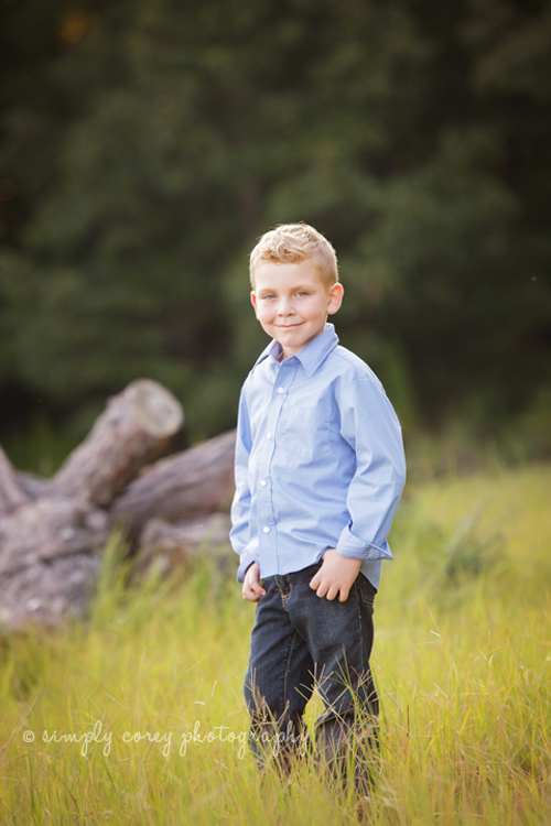 Portrait of a young boy in a field by Carrollton Children's Photographer 