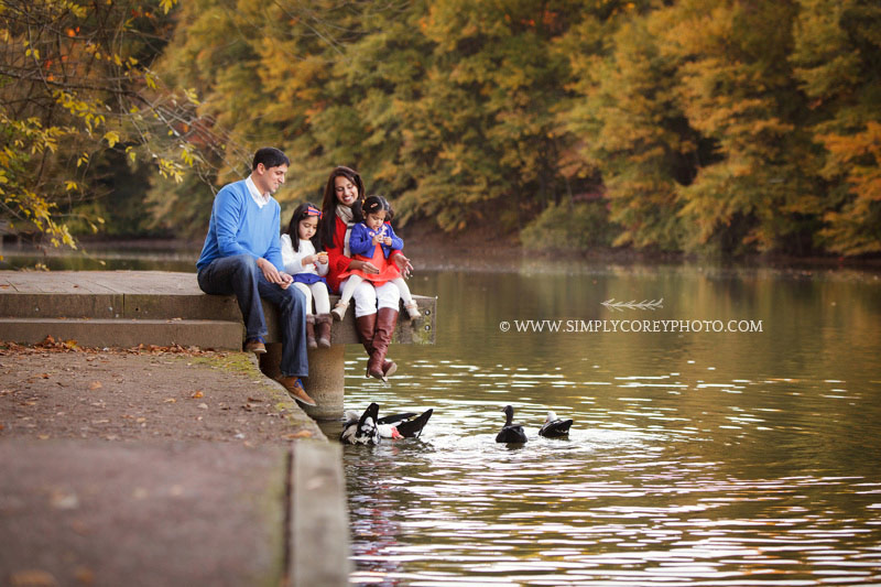 Atlanta family photographer, family feeding ducks at Piedmont Park