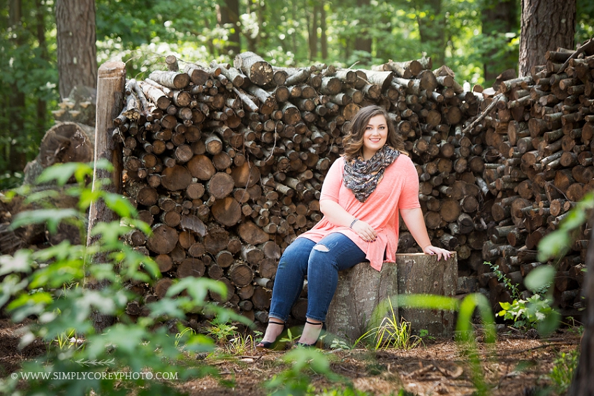 Carrollton senior portraits by a log pile 
