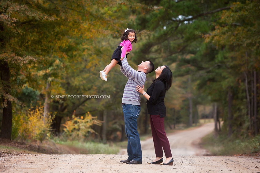 mom and dad with a toddler during an outdoor photography session by Atlanta family photographer