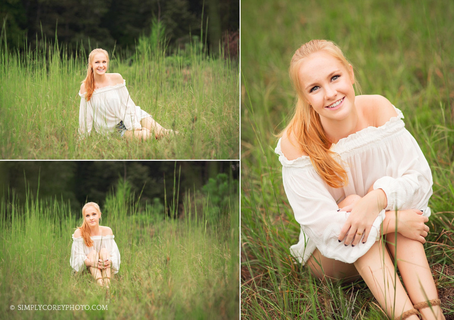 teen girl in tall grass by Carrollton senior portrait photographer