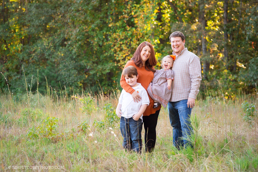 family of 4 in a field by Atlanta family photographer