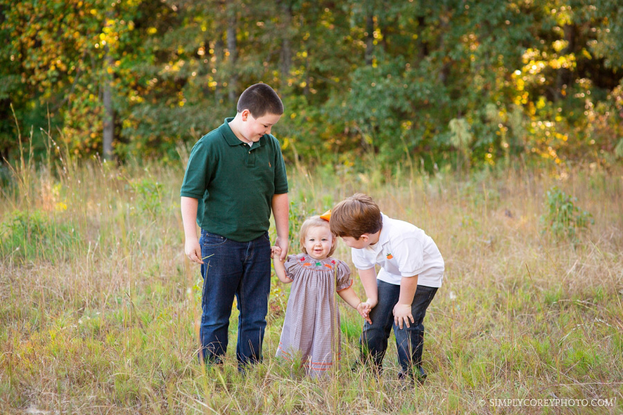 cousins in a field by Carrollton family photographer