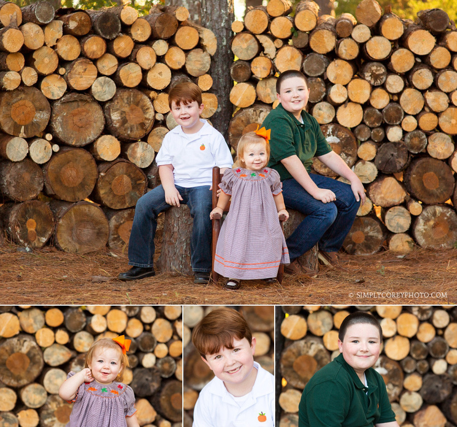 cousins in front of a log wall by Douglasville children's photographer