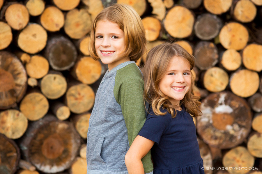 brother and sister near log pile by West Georgia kids photographer