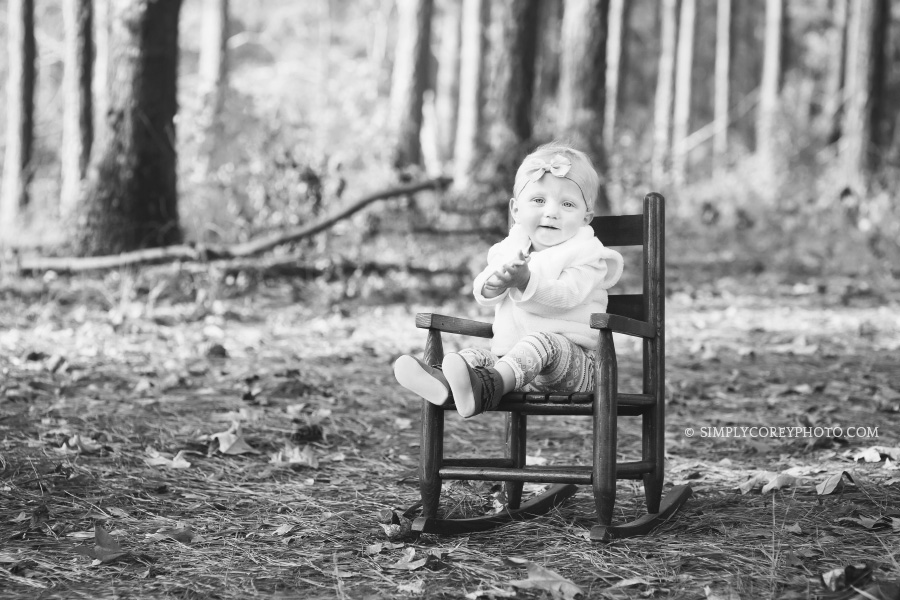 black and white outdoor portrait of a baby in a rocking chair by Atlanta baby photographer
