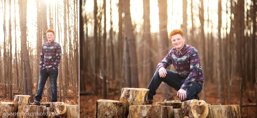 teen boy outside on logs by Atlanta senior portrait photographer