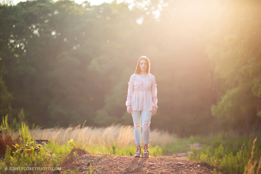 teen girl outside with sun flare, senior portrait photographer Atlanta