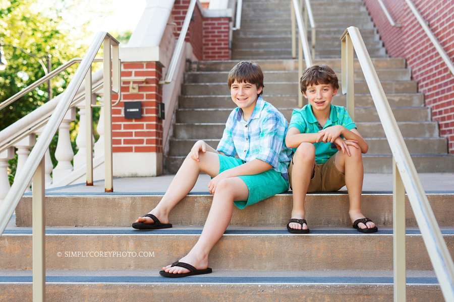 boys sitting on steps downtown by Carrollton children's photographer
