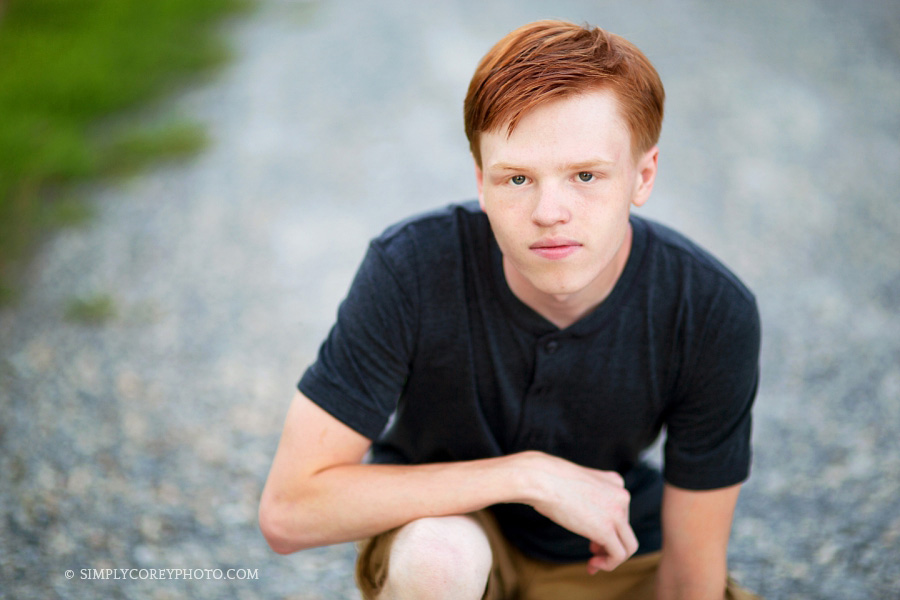 senior portrait photographer Carrollton, teen boy on gravel country road