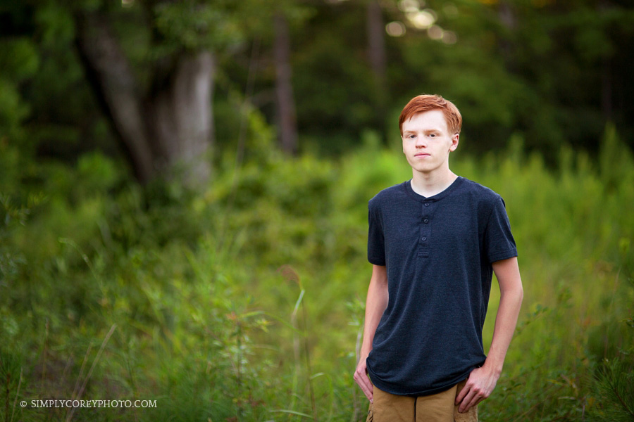 Douglasville senior portrait photography of teen boy in a country field