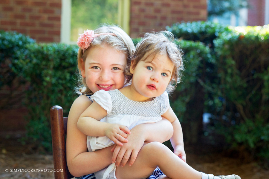 sisters outside by Douglasville family photographer