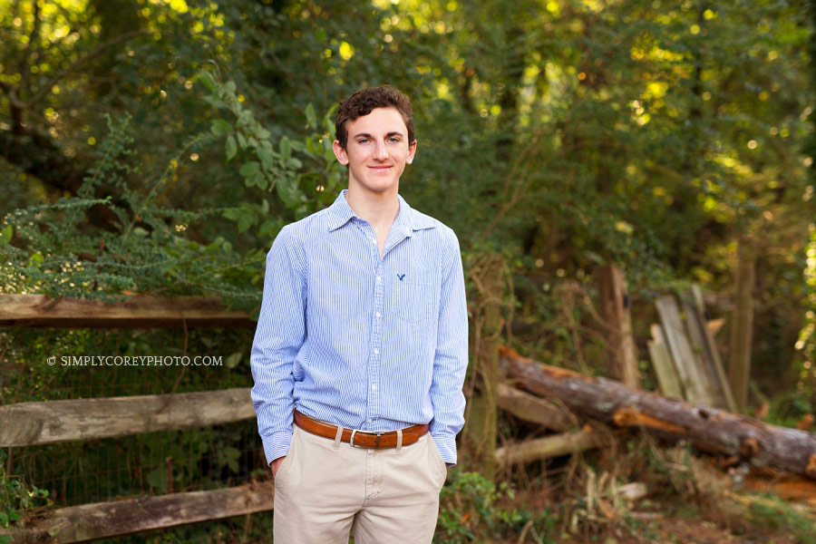 Atlanta senior portrait photography of a teen near a wood fence