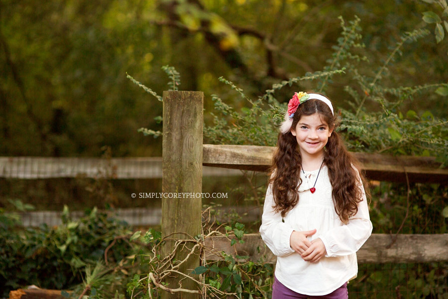 girl near a wood fence by Atlanta child photographer