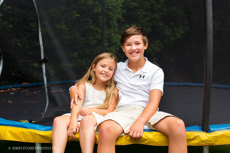 Carrollton children's photography of a brother and sister on a trampoline