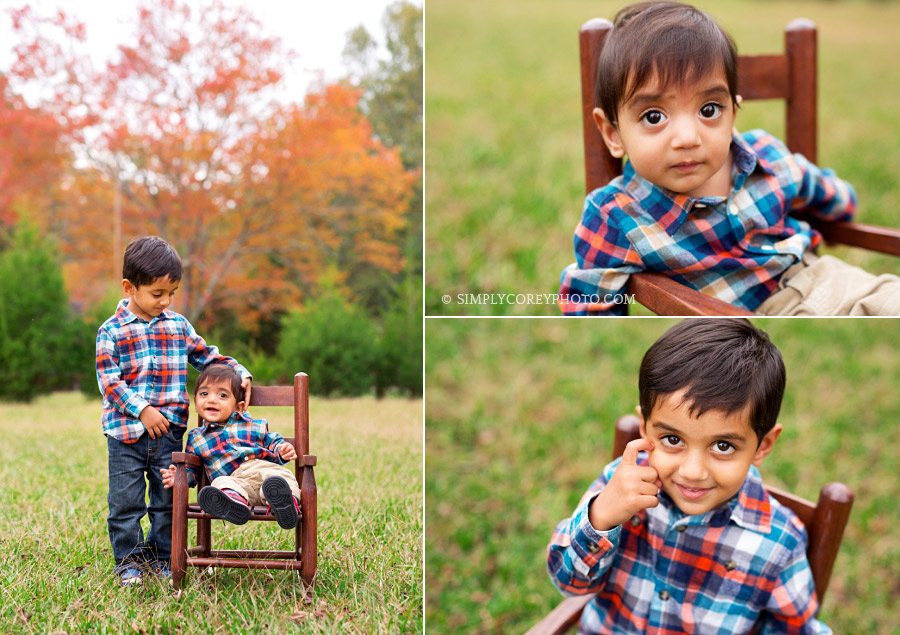 brothers in a chair outside with fall trees by Villa Rica children's photographer 