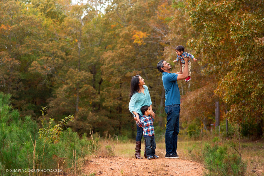 candid portrait family of four outside by Atlanta family photographer