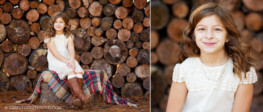 girl near a wood pile by Newnan children's photographer