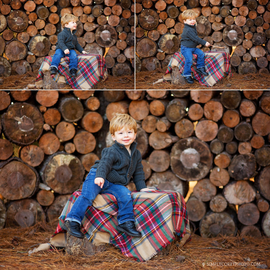 toddler boy near wood pile by Carrollton baby photographer