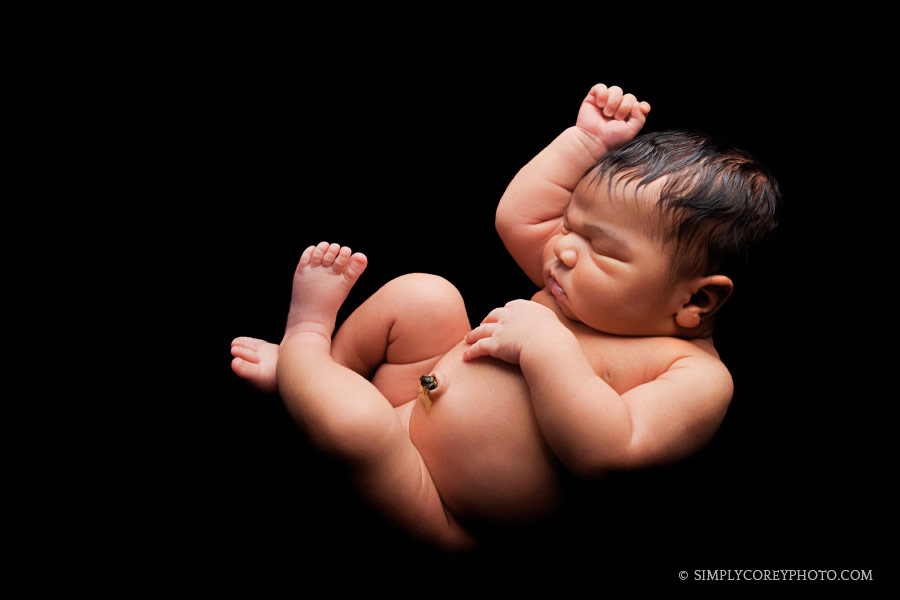 baby boy on black backdrop by Atlanta newborn photographer