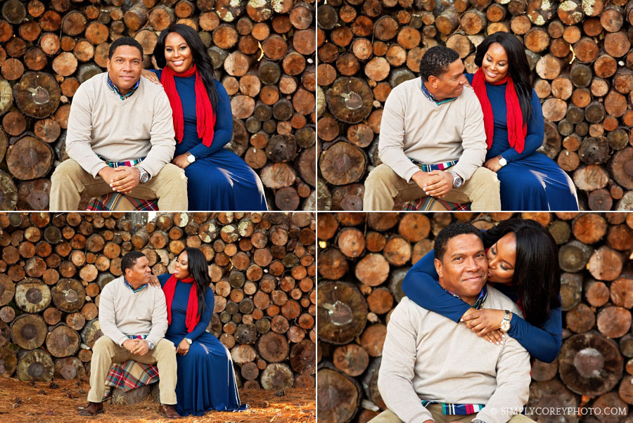 couple outside near a log wood wall by Carrollton engagement photographer