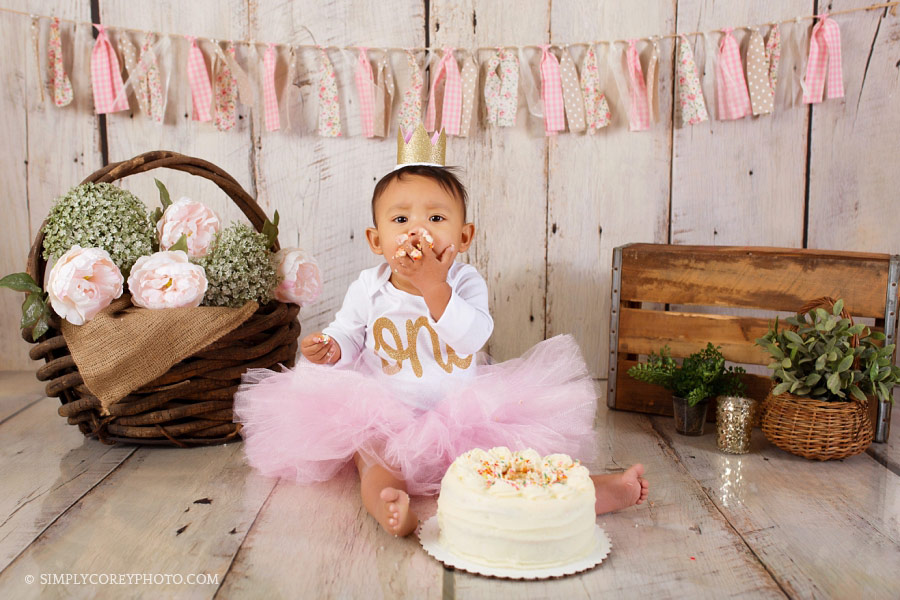 Atlanta cake smash photographer, baby girl in a pink tutu eating cake
