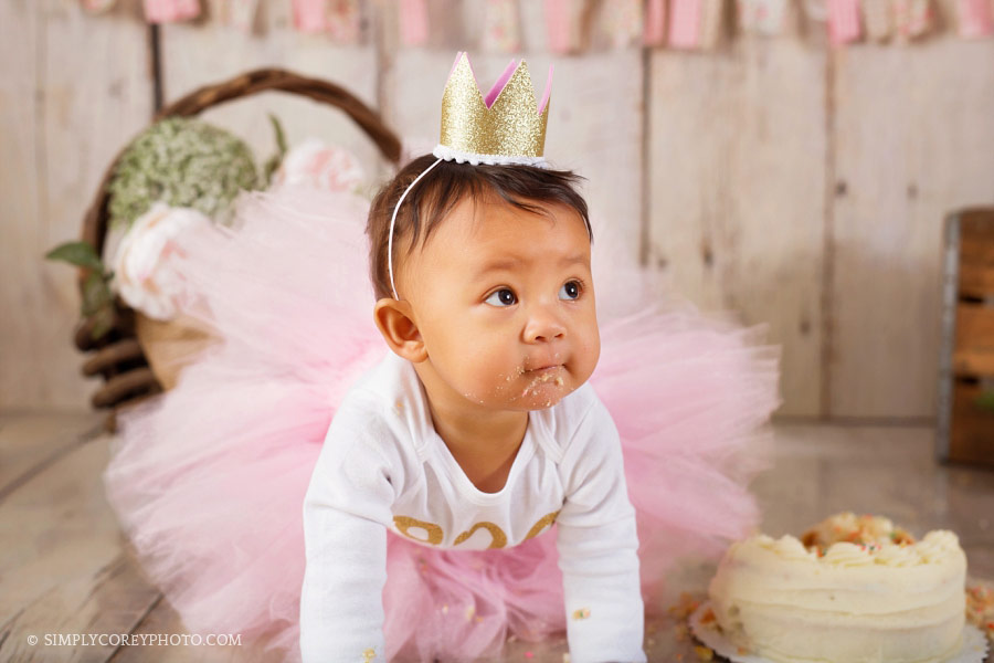 Douglasville cake smash photographer, baby girl crawling in a pink tutu and gold crown