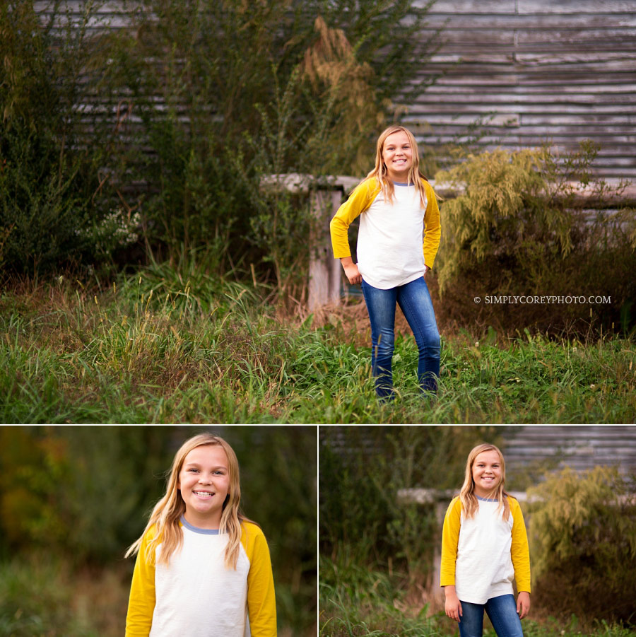 Newnan child photographer, tween girl outside in the grass by a barn