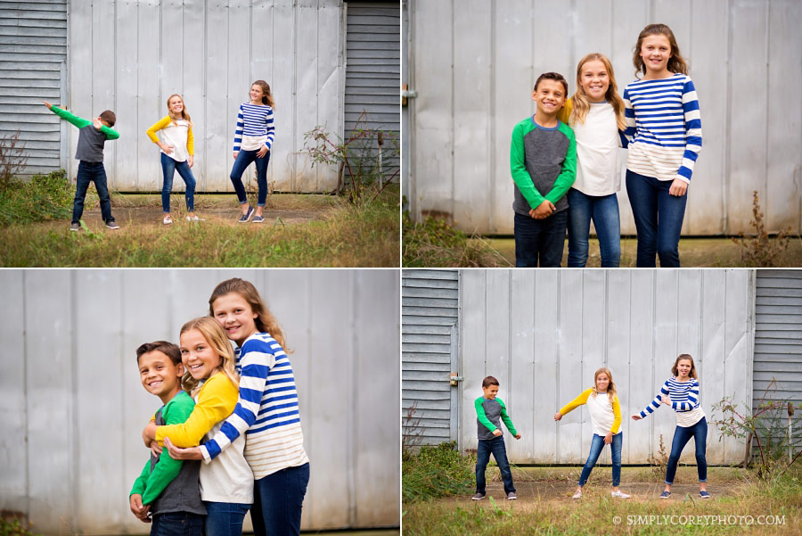 Newnan children's photographer, siblings playing and hugging outside of a barn