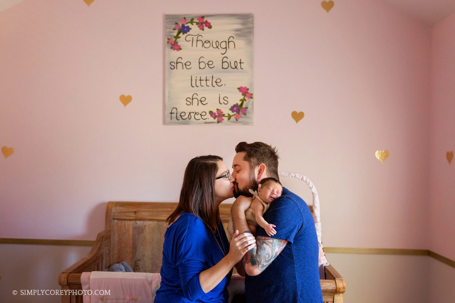 Atlanta family photographer, parents with newborn baby girl in the nursery