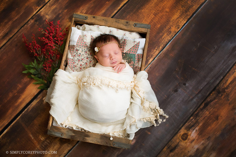 Newnan newborn photographer, baby girl on a quilt in a wood crate