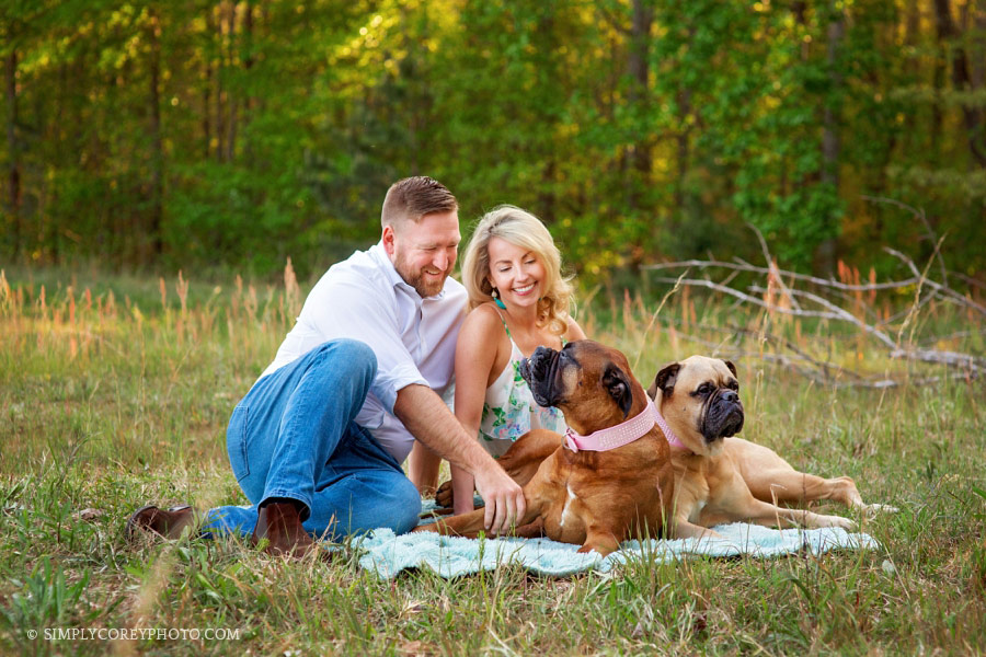 family photographer Newnan, couples with dogs on a blanket outside