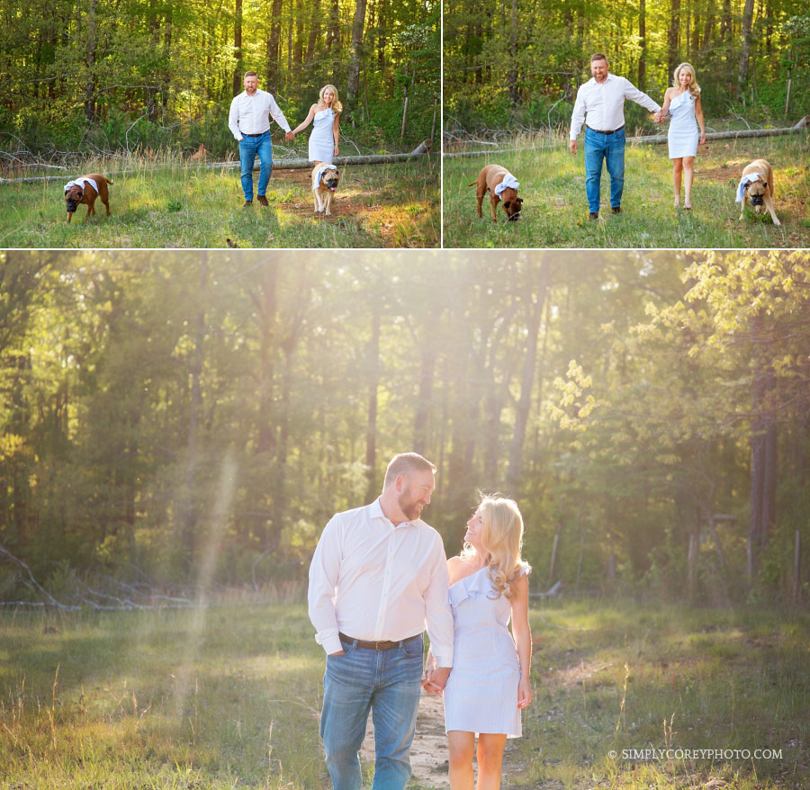 family photographer Villa Rica, couple walking with two dogs outside