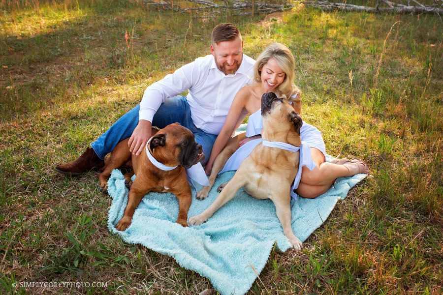 Newnan family photographer, couple with mastiff dogs outside on a blanket