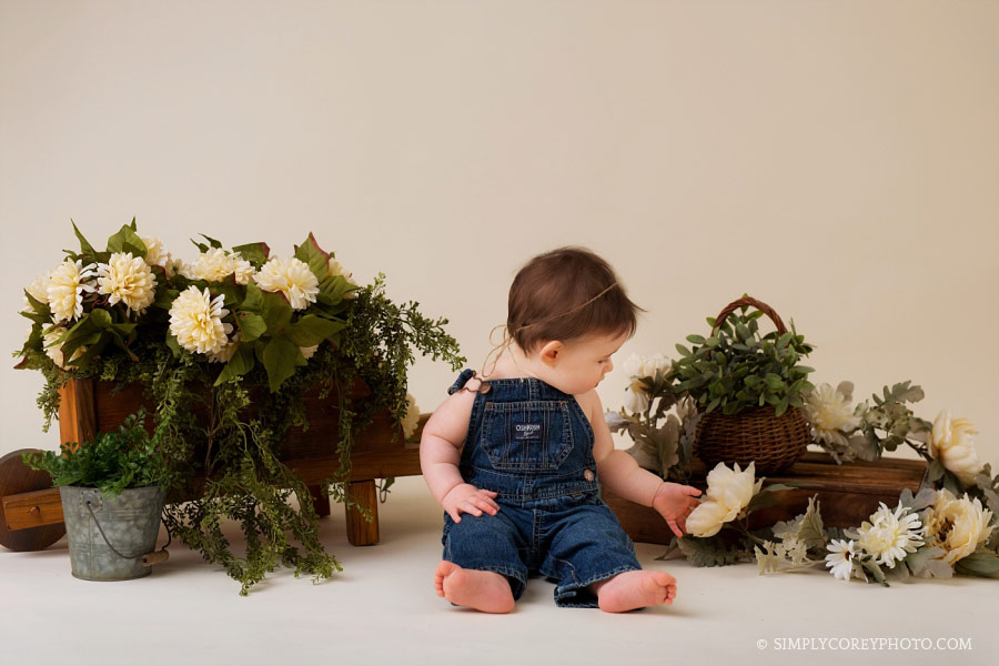 Newnan baby photographer, girl in overalls with flowers in studio