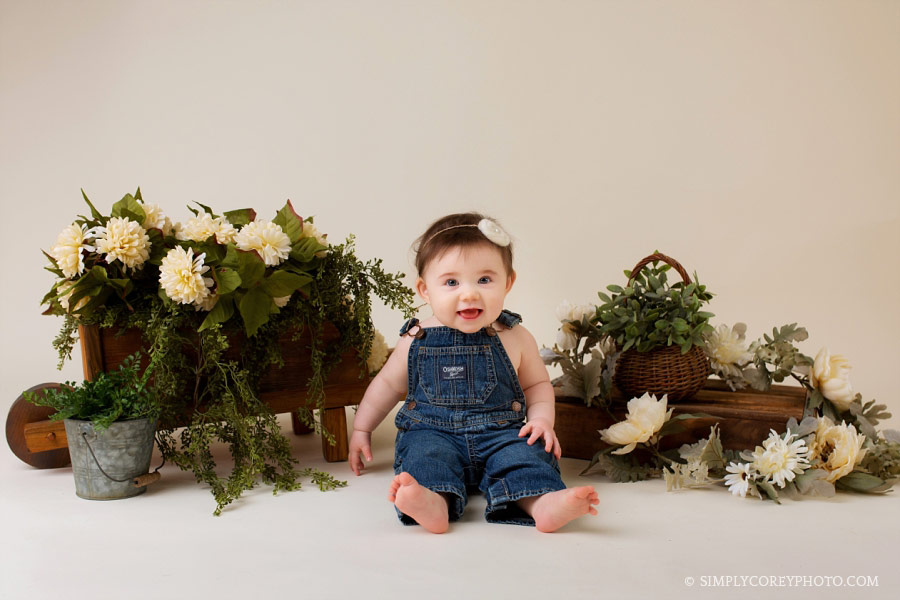 Villa Rica baby photographer, girl in overalls with flowers in studio