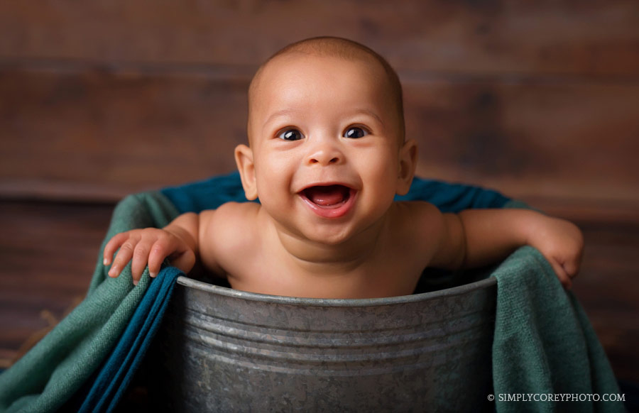 baby photographer Carrollton, Georgia; boy smiling in a bucket