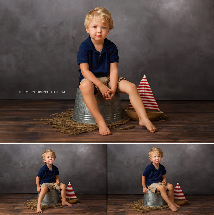 Newnan children's photographer, boy with a boat in a photography studio