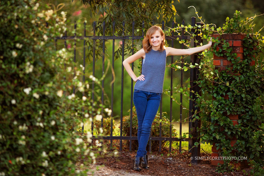 Atlanta senior portrait photography of a teen girl outside by an iron gate