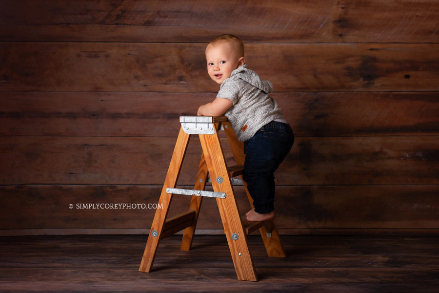baby photographer Atlanta, one year old boy climbing a ladder