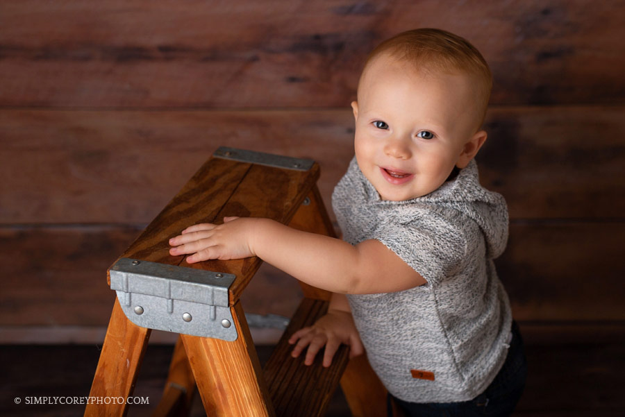 baby photography near Villa Rica; one year old boy smiling on a ladder