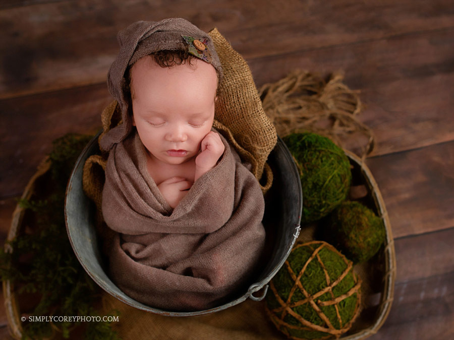 newborn photographer Villa Rica, baby boy in a bucket with a hat