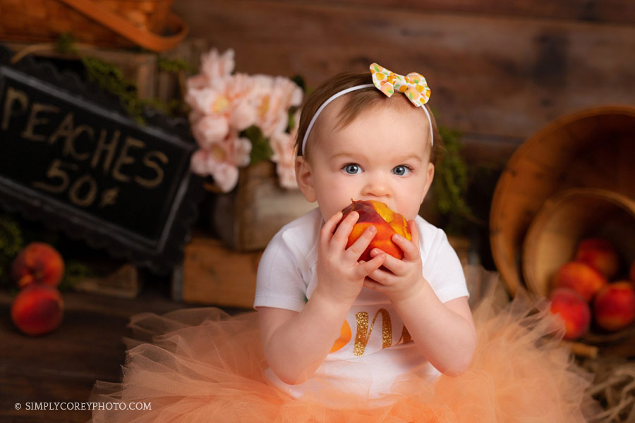 cake smash photographer Carrollton, Georgia baby eating peaches in a tutu