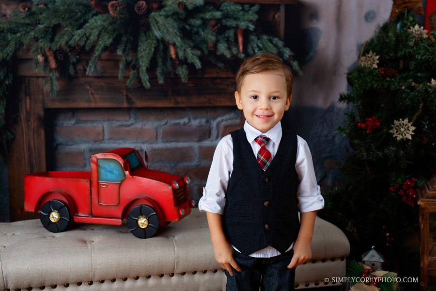 Christmas mini session near Newnan, boy with a red truck in studio
