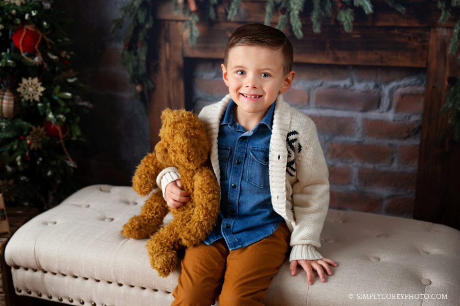 Newnan Christmas mini session with a boy holding a teddy bear in studio