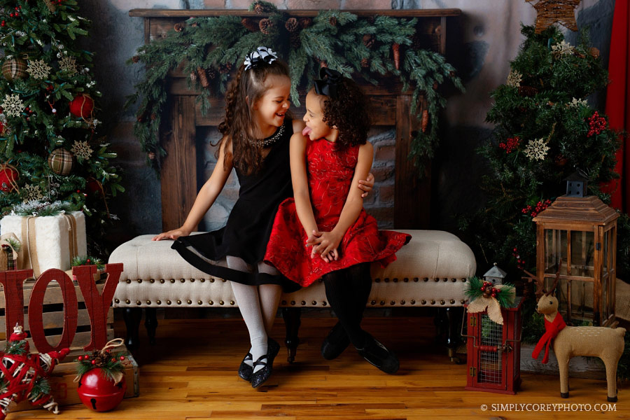 Villa Rica Christmas mini session, sisters making silly faces at each other