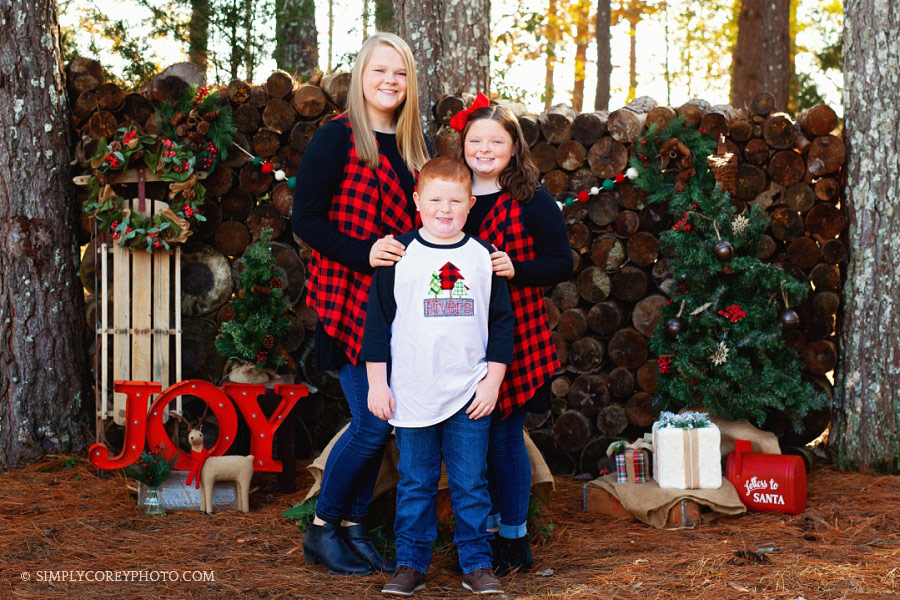 Villa Rica holiday mini session with siblings in Christmas outfits outside