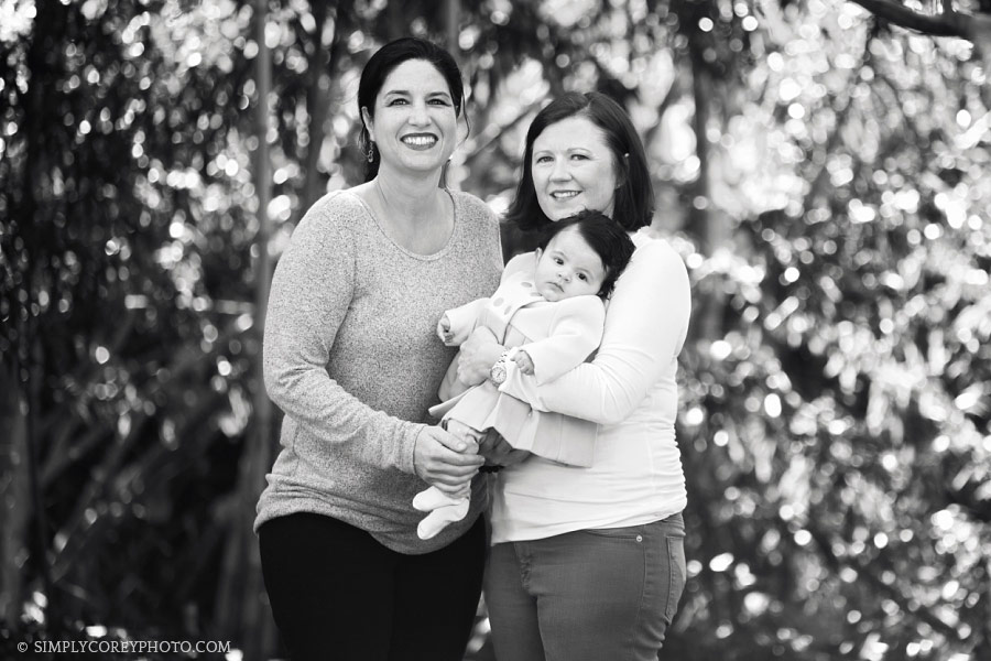 Atlanta family photographer, parents holding baby girl outside